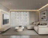 Nowoczesny salon w stylu minimalizm we wnętrzach. Jasna kanapa, telewizor na ścianie, owalny stolik kawowy i subtelne oświetlenie tworzą spokojną atmosferę.